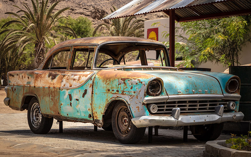 sanding a rusty car